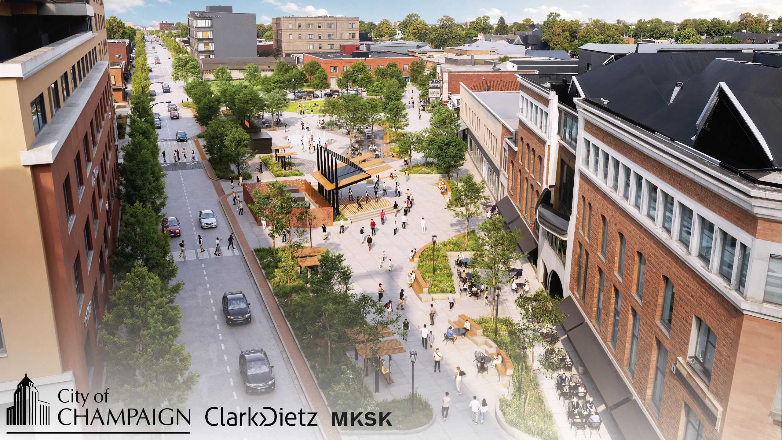 A view of the completed Downtown Plaza facing north from Neil and Main Streets. Additional bench swings, seating areas, trees, and raised planter beds are shown beyond the existing performing arts stage, along with small business kiosks and a splash pad n