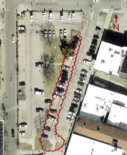 An overhead view of the Neil and Washington parking lot. A red highlighted area in the middle of the parking lot notes a closure for water main repair. The remainder of the parking lot adjacent to businesses will remain open for vehicular access and parki