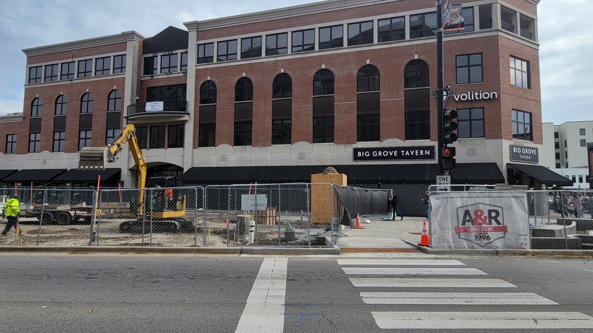 A picture of the plaza construction work facing east from the northwest corner of Neil and Church. The sidewalk on the south end of the plaza is now open, allowing pedestrians to use the east-west crosswalk on Neil north of Church/Main.