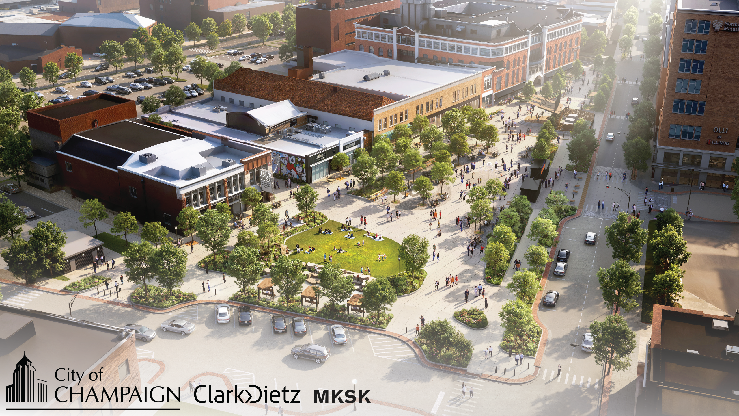 A view of the fully completed Downtown Plaza from Washington Avenue facing south. On-street parking remains available on Washington Avenue and on the east side of Neil Street. Planters, bench swings, a public restroom, a grassy lawn, and a Petanque court 